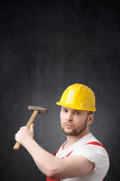 istock Portrait of a construction worker with hammer 1318666755