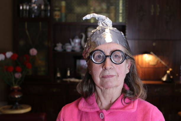 istock Distrustful senior woman wearing weird tinfoil hat 1318668202