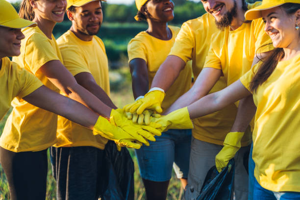 istock Group of volunteers put hands together 1318669049