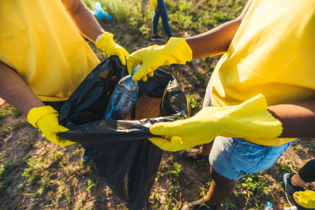 istock People cleaning up garbage in nature 1318670401