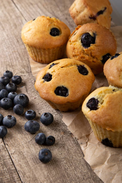 istock muffin cupcake with blueberries on a grunge wooden table. 1318670793