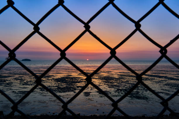 istock The sun sets over the sea 1318673159