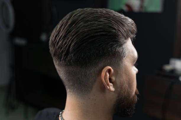 Low fade machine haircut for handsome bearded man in barbershop. Hair cut with a smooth transition. Low fade machine haircut for handsome bearded man in barbershop. Hair cut with a smooth transition fade in stock pictures, royalty-free photos & images