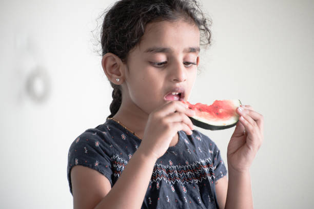 istock little girl eating watermelon 1318677791