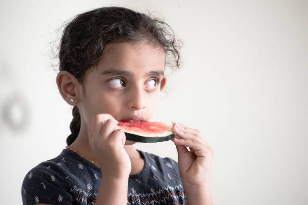 istock little girl eating watermelon 1318677902