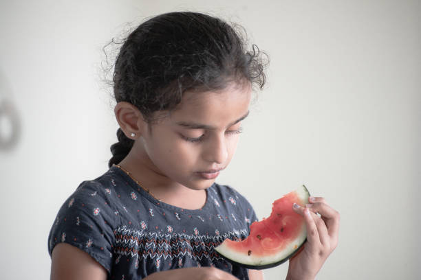istock little girl eating watermelon 1318677914