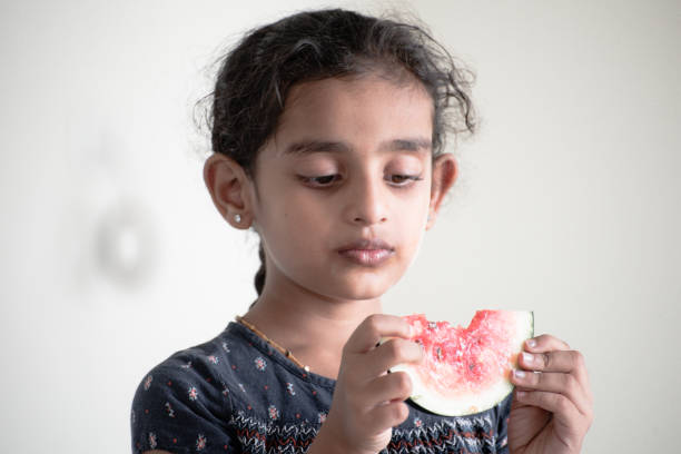istock little girl eating watermelon 1318677926