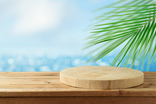 istock Empty wooden log on rustic table over blurred sea beach background.  Summer mock up for design and product display. 1318677936