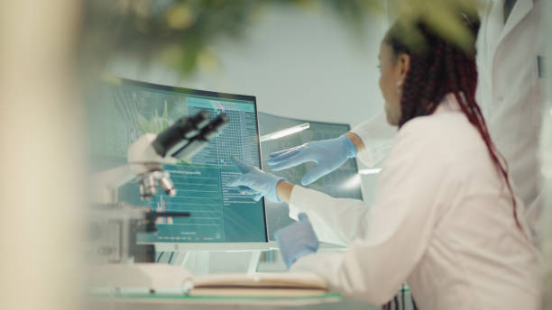 istock African ehtnicity female scientists checking medical marijuana. Laboratory tests on screens. Discussing results 1318680864