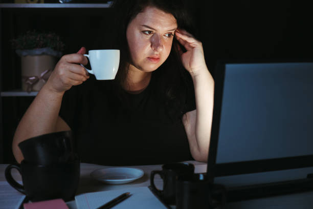 istock Woman drinking too much coffee at night work 1318681131