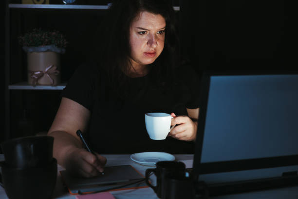istock Designer drawing at graphic tablet late at night 1318681176