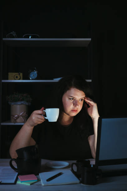 istock Woman drinking too much coffee at night work 1318681181
