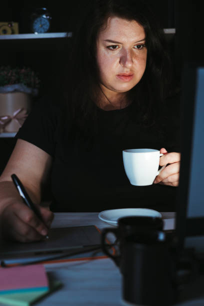 istock Designer drawing at graphic tablet late at night 1318681205