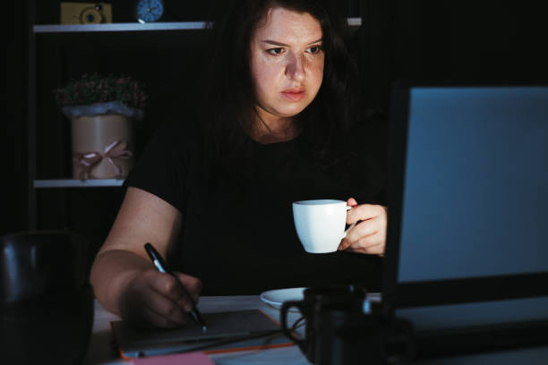 istock Designer drawing at graphic tablet late at night 1318681238