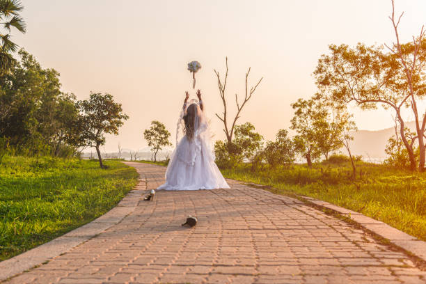 beautiful bride wearing a white wedding dress running away alone - shoe leaving women summer imagens e fotografias de stock