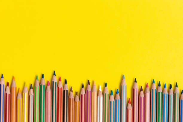 istock Colored pencils isolated on yellow background close up concept with copy space for text 1318683629