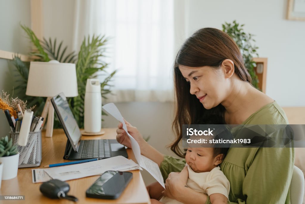 Female finances for family. Woman holding paper various expense bills and plans for personal finances at her home. Finance Stock Photo