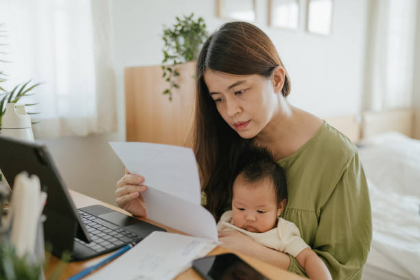 istock Mother Using Laptop To Check Finances At Home. 1318684782