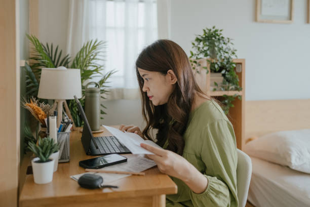 istock Mother Using Laptop To Check Finances At Home 1318684785