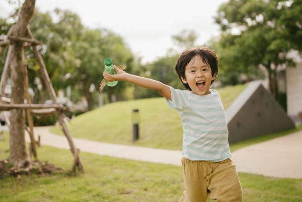 istock Asian boy running in park. 1318684794