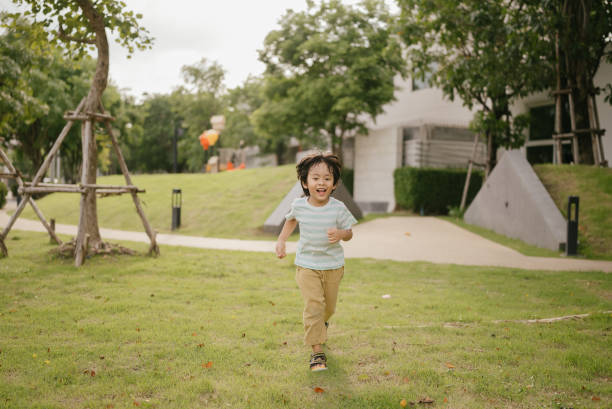 istock Asian boy running in park. 1318684797