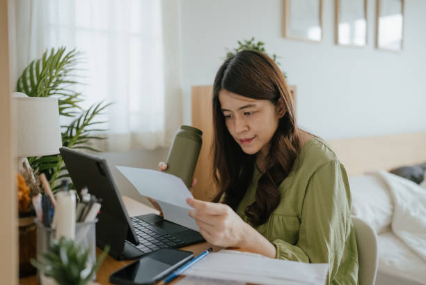 istock Mother Using Laptop To Check Finances At Home. 1318684803