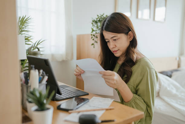 istock Mother Using Laptop To Check Finances At Home. 1318684811