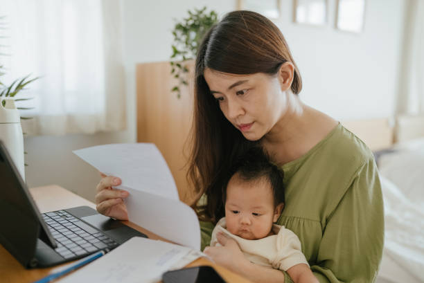 istock Mother managing home finance. 1318684836
