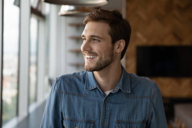istock Smiling man look in distance making decisions 1318686194