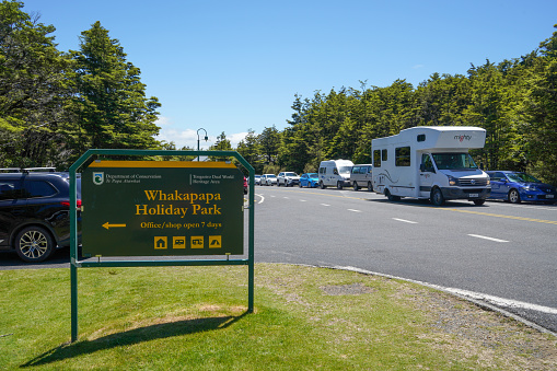 Whakapapa Holiday Park Sign at the parking lot of Tongariro National Park Visitor Centre, Mount Ruapehu, Manawatu-Wanganui, New Zealand.