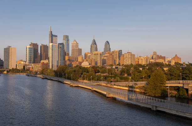 istock Philadelphia Downtown skyline with the Schuylkill river. Beautiful Sunset Light. Schuylkill River Trail in Background. City skyline glows under the beautiful sunset light 1318687158