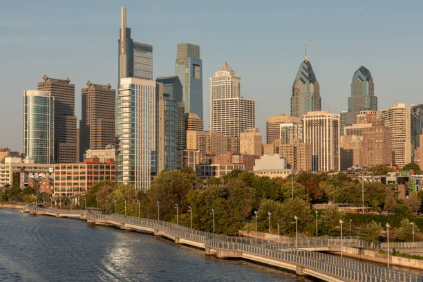 istock Philadelphia Downtown skyline with the Schuylkill river. Beautiful Sunset Light. Schuylkill River Trail in Background. City skyline glows under the beautiful sunset light 1318687363