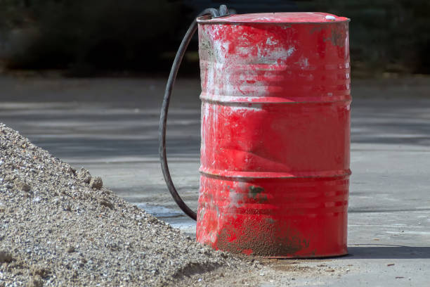 istock A battered and dirty red metal barrel with two torn hoses inserted 1318690378