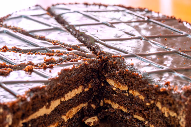 istock Chocolate cake with a cream layer. Cut into pieces. Several pieces are missing 1318690379