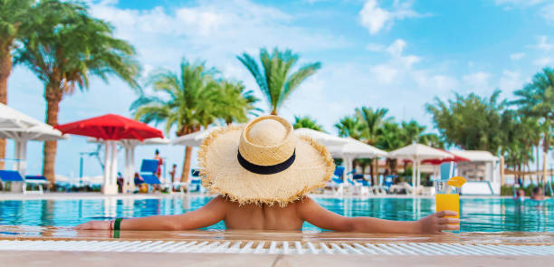 istock The child is drinking a cocktail by the pool. Selective focus. 1318690452