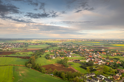 Aerial view of the rural landscape with the city of Opole on the horizon on a beautiful spring day.