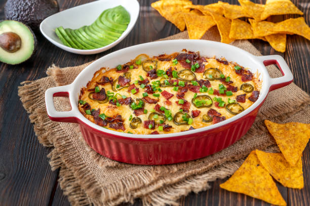 Dish of Jalapeno popper dip Dish of Jalapeno popper dip with cheese and bacon dipping stock pictures, royalty-free photos & images