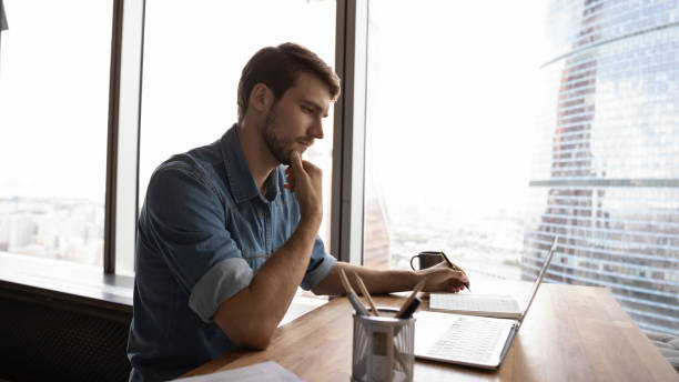 istock Serious Caucasian man work on laptop thinking 1318692322