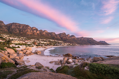 Beautiful Camps Bay, Cape Town on the Cape Peninsula, over looking the Atlantic ocean on a clear day in spring with tourists tanning and sunbathing