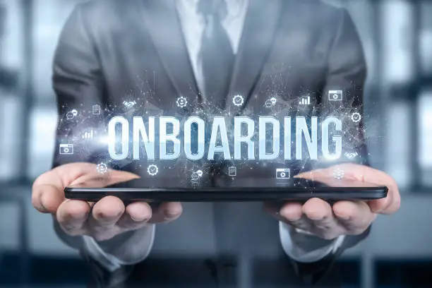 Photo of Businessman shows on the tablet the word onboarding .