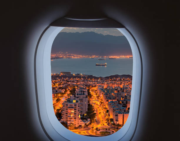aerial view of window from landing airplane, night eilat and aqaba cities - gulf of aqaba imagens e fotografias de stock