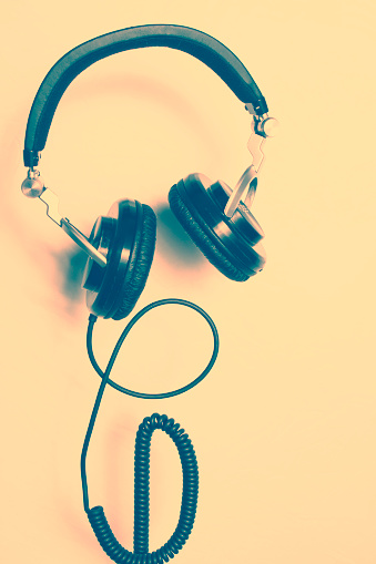 Headphone on colored background. Retro style