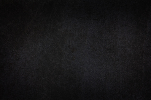 Black dark wall with vignetting and light spots. Minimalistic template for Halloween posters and banners