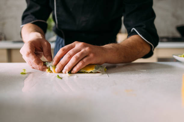 istock Anonymous Male Caucasian Professional Chef Preparing Tasty Meals in a Private Kitchen 1318706122