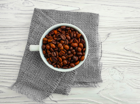 cup of coffee, grain on a wooden background