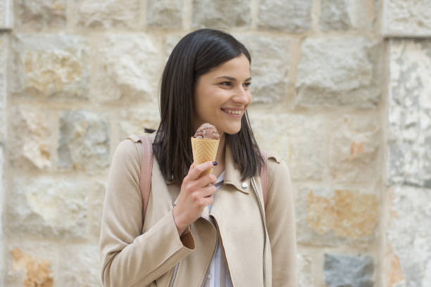 istock Modern young woman eating ice-cream 1318707364