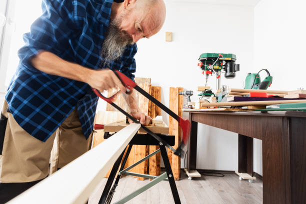 istock Woodworking, cutting wood plank using hand saw 1318711401