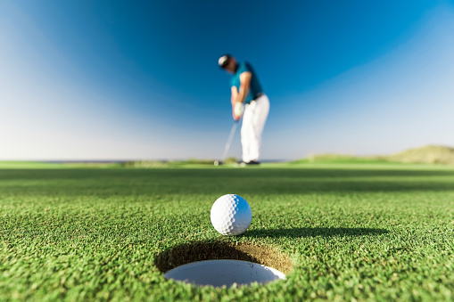 View of golf course with green grass and forest with beautiful putting green with rich green landscape