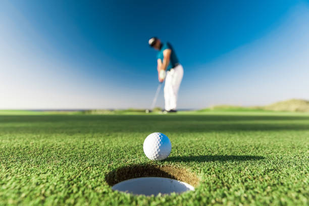 Golf player making a successful stroke - Links Golf Links golf style. A links is the oldest style of golf course, first developed in Scotland. The word "links" comes via the Scots language from the Old English word hlinc: "rising ground, ridge" and refers to an area of coastal sand dunes and sometimes to open parkland. golfer stock pictures, royalty-free photos & images