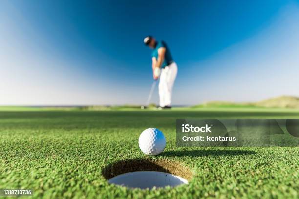 Golf Player Making A Successful Stroke Links Golf Stock Photo - Download Image Now